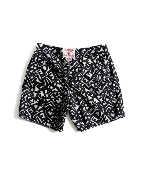The 300 Boardshorts - Alphabet Soup feature a black and white geometric pattern, a back pocket with button, visible waistband brand label, and classic water-repellent boardshort style displayed flat.