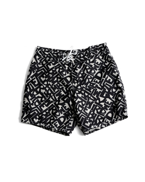 The 300 Boardshorts - Alphabet Soup are black SurfNyl boardshorts with an all-over white abstract text pattern, a white drawstring waist, and water-repellent fabric. Made in the USA for style and durability.