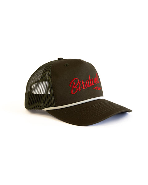 The Script Twill Trucker - Olive/Red is a 5 panel olive mesh hat with a curved brim, red Birdwell U.S.A. embroidery on the front, a white accent stripe above the brim, mesh back for ventilation, and an adjustable embroidered snapback closure.