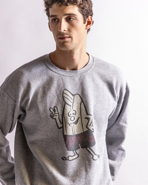 A man wears the Birdie Crewneck Sweatshirt in heather gray, showcasing a cartoon banana flashing a peace sign in a bold graphic on the front, set against a plain light background for a vintage vibe.