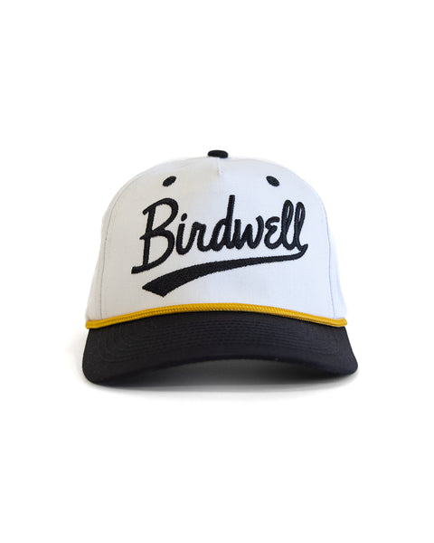 The Baller Twill Snapback - White/Black is a white 5-panel hat with a black bill, yellow trim, and 