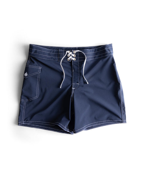 The 806 SurfStretch Side Pocket Boardshorts in navy feature white stitching, a lace-up front, and a side pocket, shown laid flat on a white background.