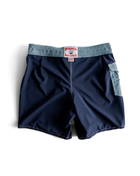 The 808 SurfStretch Pop Pocket Boardshorts in Navy/Federal Blue feature a light gray waistband, side pocket, and red-and-white Birdwell label on the front. Proudly made in the USA and shown on a white background.