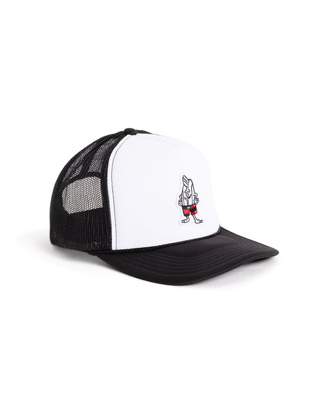 The Birdie Trucker - Black/White is a 5-panel, black and white foam trucker hat with a mesh back, featuring a cartoon walking banana in red shoes on the front.
