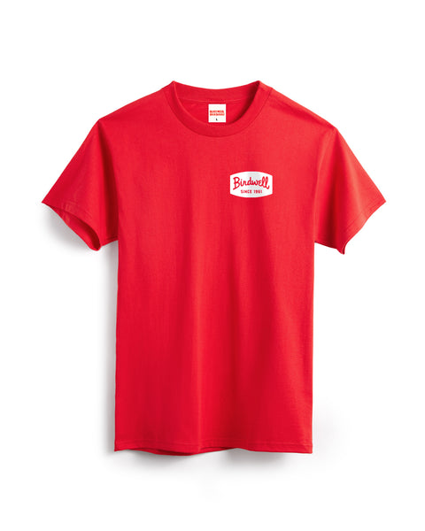 The Herald T-Shirt - Fuji Red is a heavyweight, short-sleeve cotton tee with a small white patch on the left chest reading 