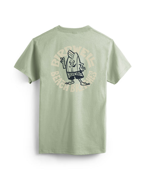 The Rounder T-Shirt in Desert Green is a garment-dyed tee with a cartoon character holding a surfboard and “Birdwell Beach Britches” in a circular pattern on the back.