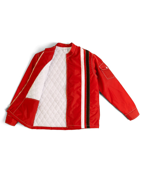 The Quilt Lined Racing Jacket - Red/White/Black features bold white and black stripes, a partially open front zip revealing quilted lining, and a buttoned sleeve pocket, blending comfort with sporty style.