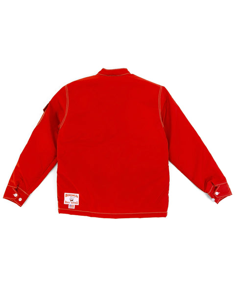 The Quilt Lined Racing Jacket - Red/White/Black is shown from the back with white stitching, buttoned cuffs, and two white patches near the lower left hem.