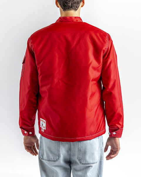 A person wearing a Quilt Lined Racing Jacket in red, white, and black with light blue jeans is shown from the back, standing against a plain white background.