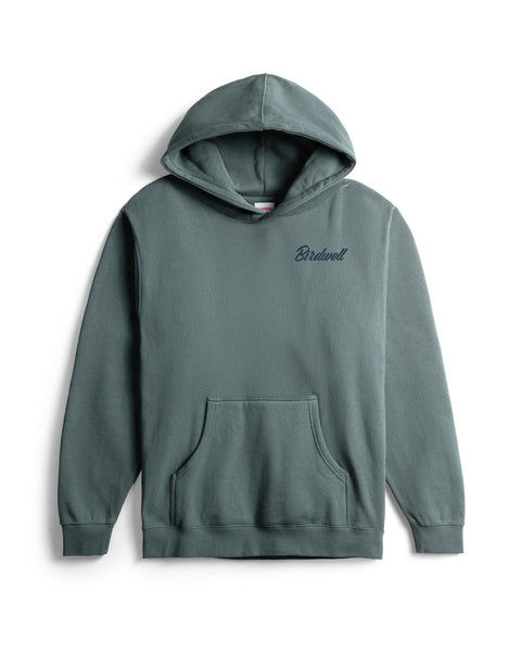 The Pau Hoodie in Atlantic Blue is a heavyweight, relaxed-fit hoodie with a front pocket and small, navy blue 