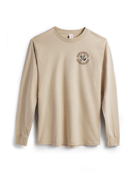The Rounder Long Sleeve T-Shirt - Sand is a beige cotton tee featuring a small, circular Birdwell Beach Britches logo and the number 8 on the left chest. Garment-dyed and shown flat against a white background.