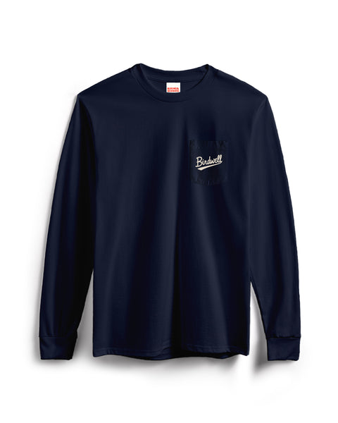 The Baller Long Sleeve Pocket T-Shirt - Navy is a heavyweight, garment-dyed tee with a front chest pocket featuring “Budwell” embroidered in white. The shirt is displayed on a plain white background.