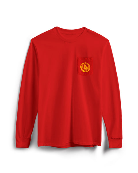 The Shaka Long Sleeve Pocket T-Shirt - Tomato is a red, garment-dyed cotton long sleeve with a chest pocket featuring a yellow circular logo with text and a lion graphic. Made in the USA, it’s shown on a white background.