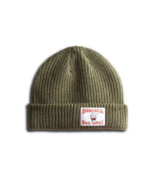 The License Plate Watchcap - Army is an olive green, ribbed fisherman-style beanie with a folded brim and a bold Birdwell patch—white with red accents—on the front cuff.