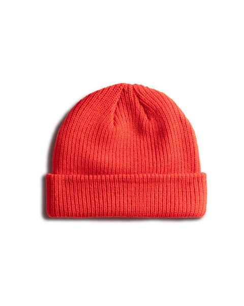 The License Plate Watchcap - Red is a vibrant ribbed beanie with a folded brim, shown on a white background. This classic fisherman-style hat is perfect for any season.