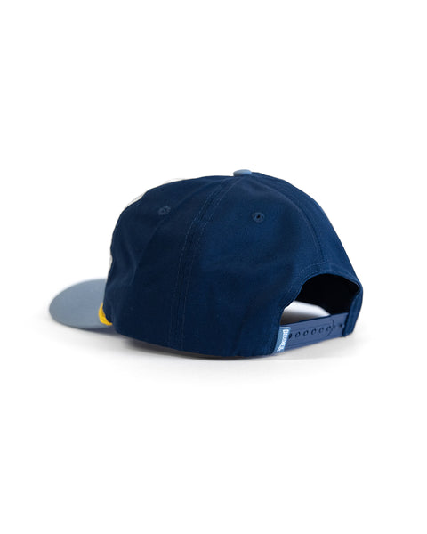 The Potato Patch Twill Snapback in Bone/Federal Blue is a cotton hat with a light blue adjustable strap, displayed from the back on a white background.