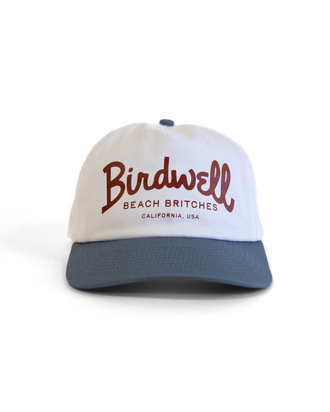 The Big Arc Twill Snapback - White/Federal Blue is a white, unstructured 5-panel hat with a federal blue brim, featuring red 