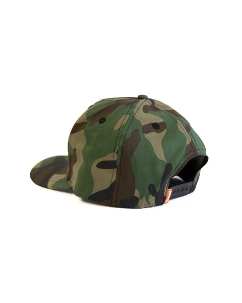 The Potato Patch Twill Snapback - Woodland Camo is a green camo 5 panel hat, shown from the back with an adjustable black snapback closure and high crown, angled slightly left on a white background.