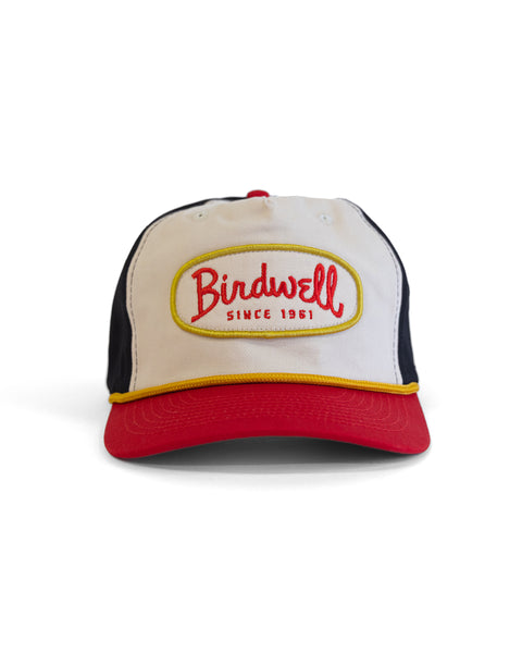The Potato Patch Twill Snapback in Bone/Red/Black is a cotton hat with a red brim and black snapback, featuring a front patch that reads 