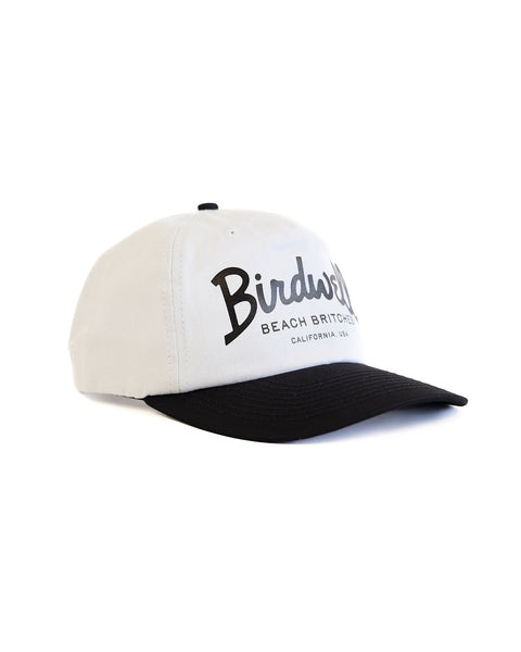 The Big Arc Twill Snapback - White/Black is a 5-panel, unstructured hat with a white crown, black brim, and 