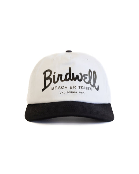 The Big Arc Twill Snapback - White/Black is a white cotton hat with a black brim, featuring 