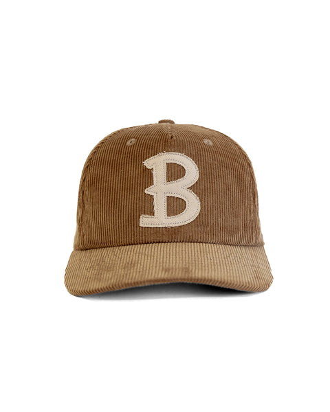 The Big B Cord Snapback - Brown is a brown corduroy 5-panel baseball cap featuring a large white embroidered 
