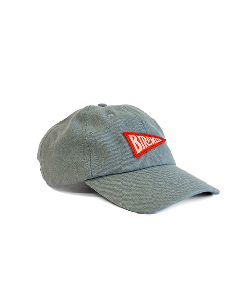 A medium wash denim dad hat with a red and white rectangular BIRDWATCH patch on the front, shown angled against a white background. Product name: Daddy Denim Hat - Medium Wash.
