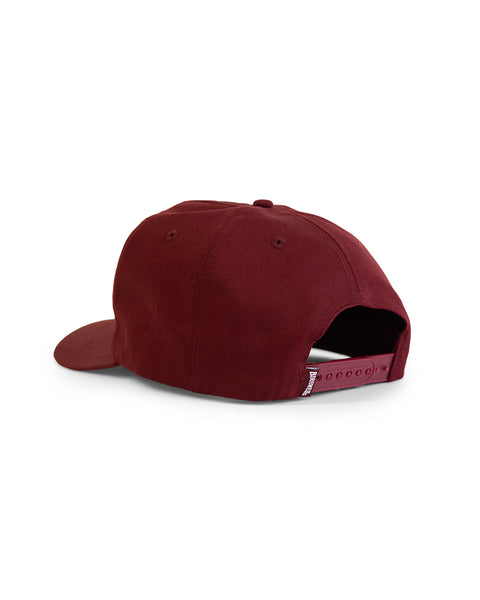 The OG Twill Snapback - Burgundy is a maroon 5-panel hat shown from the back, with an adjustable snapback closure and curved brim. It's made from soft cotton twill and displayed against a white background.
