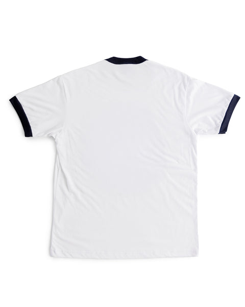 The Tourist Ringer T-Shirt - Navy/White is made in the USA, seen from the back, and features navy trim on the collar and sleeve cuffs.