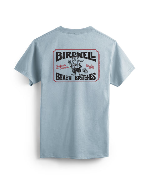 The Hangtag T-Shirt - Arctic Blue is a heavyweight cotton tee, garment-dyed for softness. It features a large black, red, and white “Birdwell Beach Britches” graphic with a cartoon man holding two towels on the back.