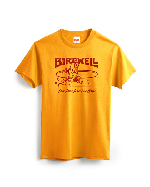 The B-Line T-Shirt - Gold is a bright yellow cotton heavyweight tee with a red cartoon surfing bird, 