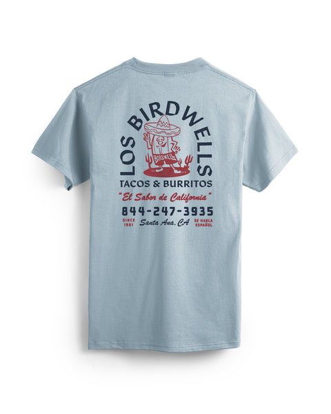 The Los Birdwells T-Shirt - Arctic Blue features a cartoon taco in a sombrero graphic on the back, 
