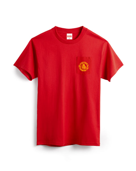 The Shaka Pocket T-Shirt - Tomato is a heavyweight red cotton tee featuring a small yellow and red circular emblem on the left chest pocket, made in the USA and shown on a white background.