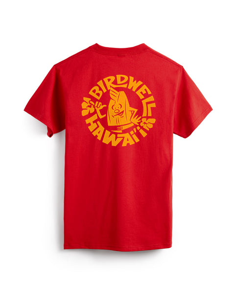 The Shaka Pocket T-Shirt - Tomato is a heavyweight cotton tee made in the USA, featuring a bold BIRDWELL HAWAI‘I graphic and a smiling surfing banana flashing shaka signs on the back.