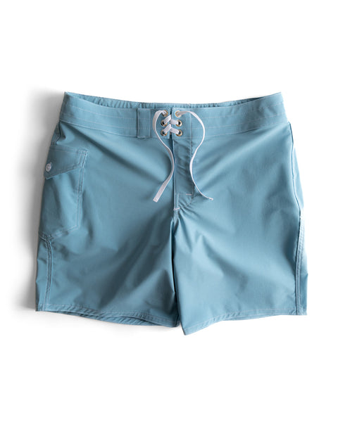 The 808 SurfStretch Side Pocket Boardshorts in light blue feature a lace-up front closure and a side pocket, shown flat against a white background.