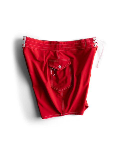 808 SurfStretch Side Pocket Boardshorts in bright red with white drawstrings and stitching, featuring a right-side flap pocket with a button, displayed on a white background.