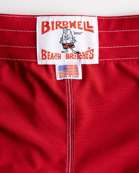 The 808 SurfStretch Side Pocket Boardshorts in red feature white stitching, a Birdwell Beach Britches label, and a Made in U.S.A. tag.