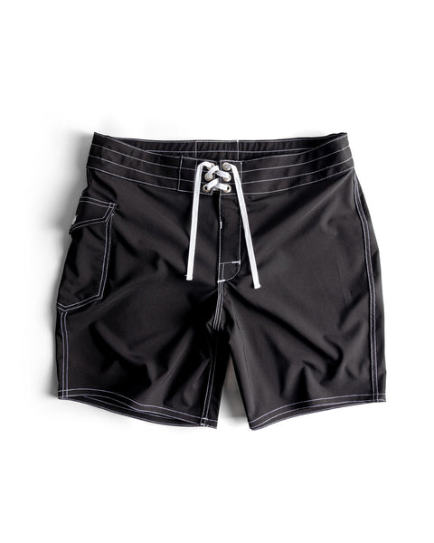 808 SurfStretch Side Pocket Boardshorts in black, featuring white drawstrings, contrast stitching, a side pocket, and lace-up front closure, displayed laid flat on a white background.