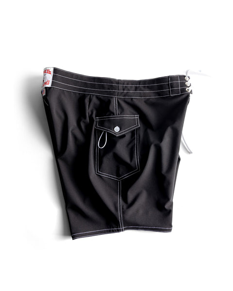 The 808 SurfStretch Side Pocket Boardshorts in black feature white stitching, a button-flap side pocket, and white drawstring laces at the waistband, shown against a white background.