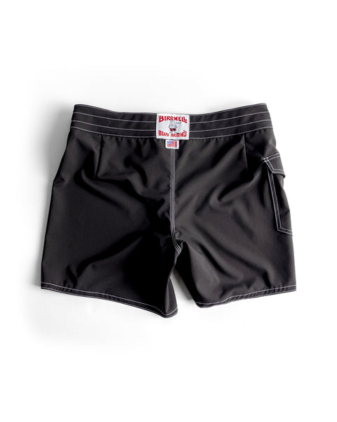 806 SurfStretch Side Pocket Boardshorts - Black, featuring white stitching, a side pocket, and a red & white Birdwell patch on the waistband. Made in the USA and displayed flat on a white background.