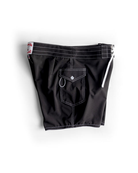 The 806 SurfStretch Side Pocket Boardshorts in black feature white stitching, a white drawstring, and a front flap pocket with a button and small metal loop.