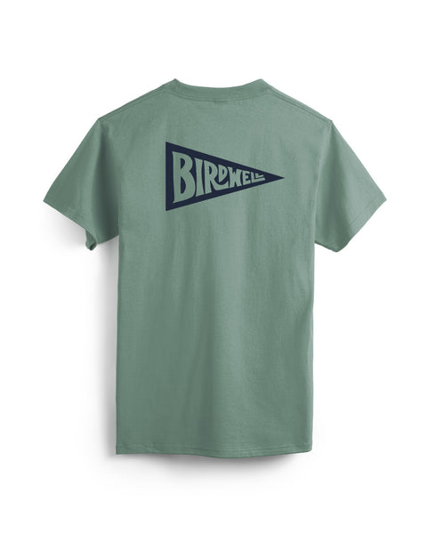 The Pennant Pocket T-Shirt in Atlantic Green is displayed flat, showing a navy blue pennant graphic with bold BIRDWELL lettering on the back. Made in the USA.