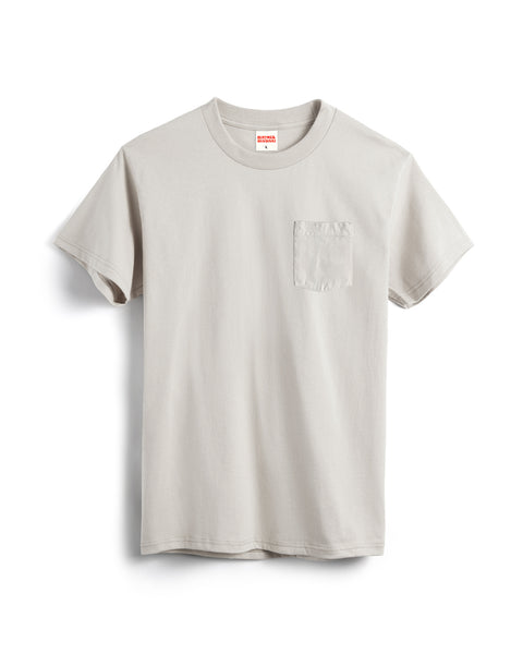 The Pennant Pocket T-Shirt - Cement is a light gray cotton tee with a chest pocket, made in the USA and shown against a white background.