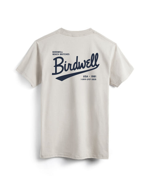 The Baller Pocket T-Shirt - Cement is a heavyweight white cotton tee, garment-dyed and made in the USA, shown on a hanger with large blue 