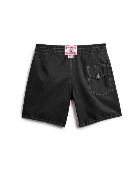 The 300 Boardshorts in black are shown from the back, featuring a single right-side flap pocket with button closure and a red Birkenstock label above the waistband. Classic medium-length boardshort style.