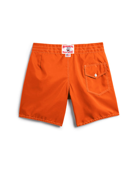 Medium orange 300 Boardshorts shown from the back with a single flap pocket and button on the right, plus a white label with red text inside the waistband. Classic boardshorts style, made in the USA.