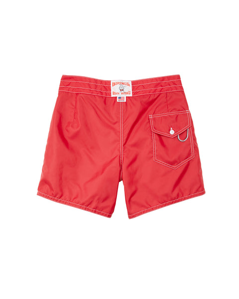 The 310 Boardshorts - Red are bright red board shorts made from SurfNyl fabric with white stitching, shown from the back. They feature a flap pocket with button closure, white embroidered logo on the pocket, and a white label on the waistband.