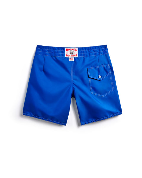 310 Boardshorts - Royal Blue: Classic surf shorts with a right back pocket and button flap, plus a white and red waistband label. Birdwell board shorts shown laid flat on a white background.