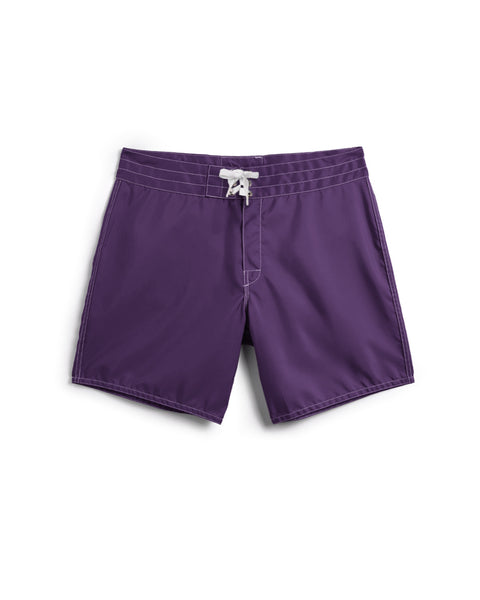 The 310 Boardshorts in purple, featuring white stitching and a white drawstring at the waist, are laid flat on a white background.