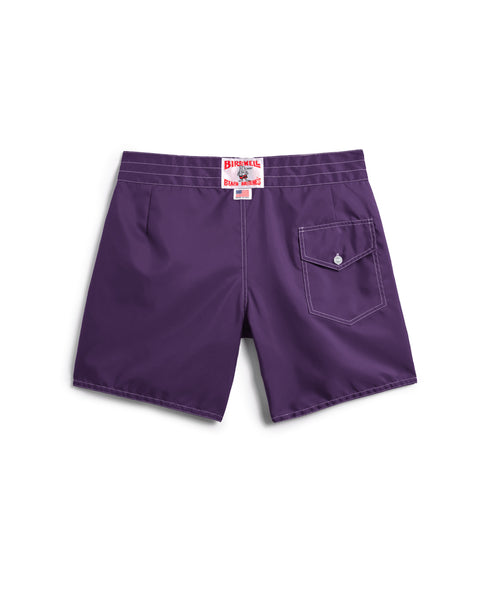 The 310 Boardshorts in purple are shown from the back, featuring a single right-side flap pocket, white stitching, and a white Birdwell label with red text above the waistband.